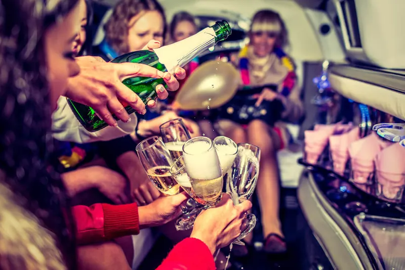 Guests celebrating with champagne aboard a Kentucky Legacy Tours limo van